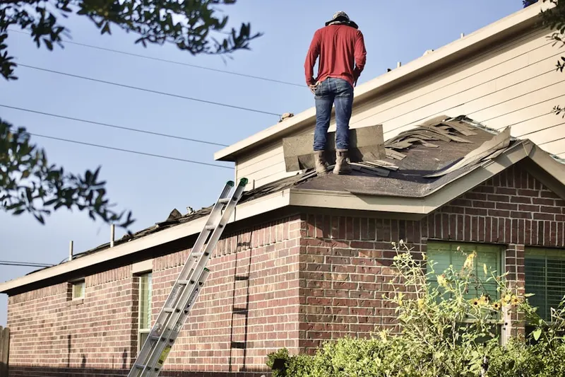 Professional roofer working on a residential roof in Camp Breezy Meadow